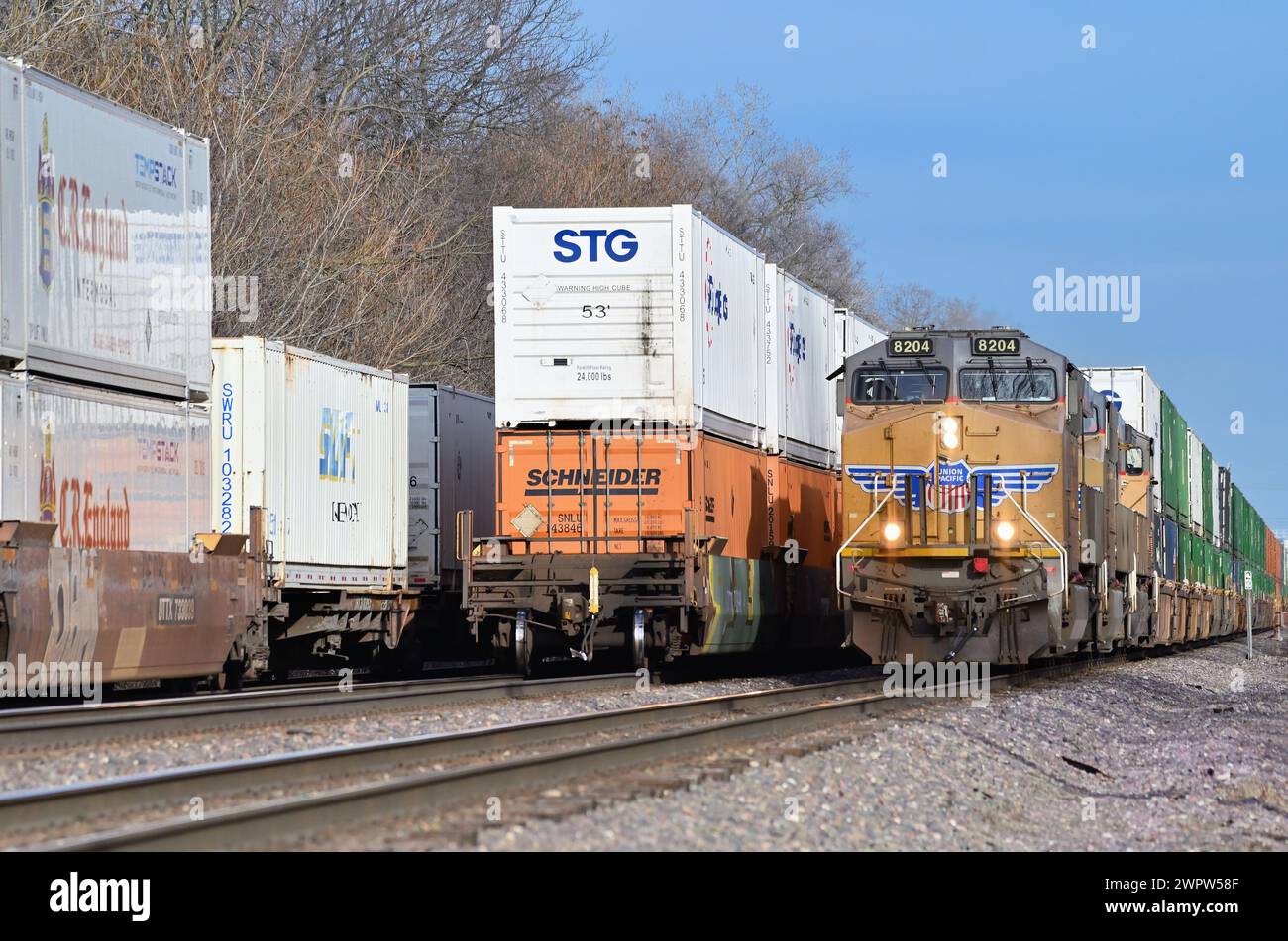 Glen Ellyn, Illinois, USA. Intermodal freight trains occupying all three tracks of a busy Union Pacific Railroad subdivision. Stock Photo