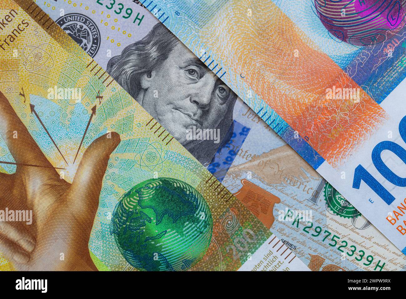 Closeup of 100 and 200 Swiss franc banknotes and 100 dollar banknote ...