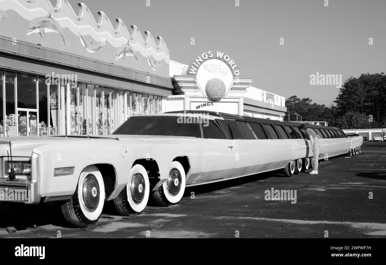 Stock photo of woman looking in the window of the worlds longest limousine at Myrtle Beach, South Carolina, USA. Stock Photo