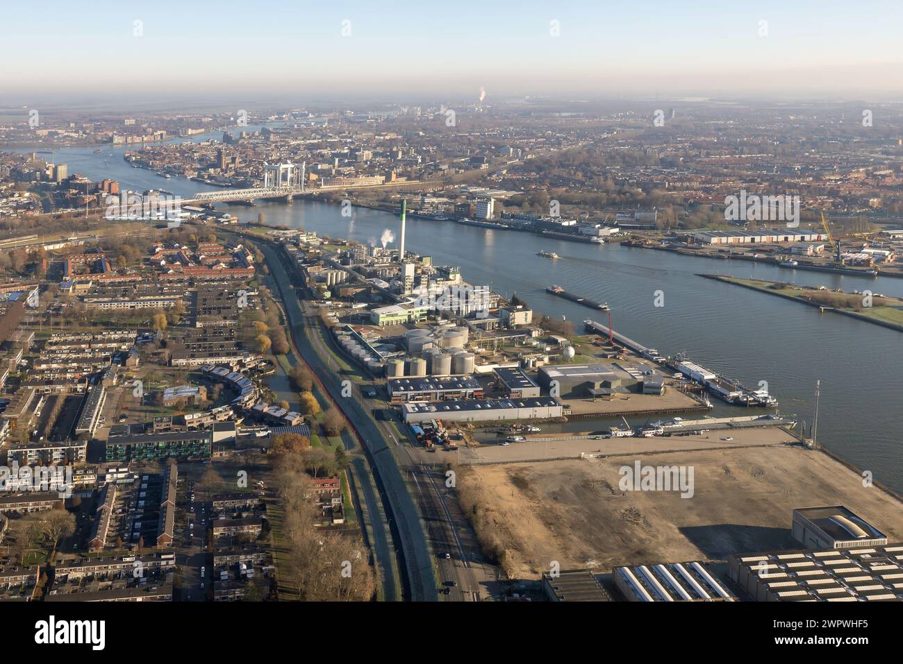 Aerial view Dutch city Dordrecht with industrial buildings along river ...