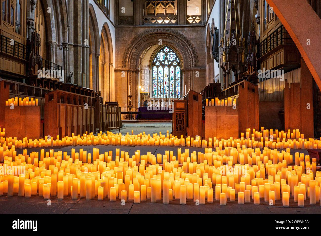 Candle lit interior of Llandaff Cathedral, Cardiff, Wales. Hundreds of candles lighting up
