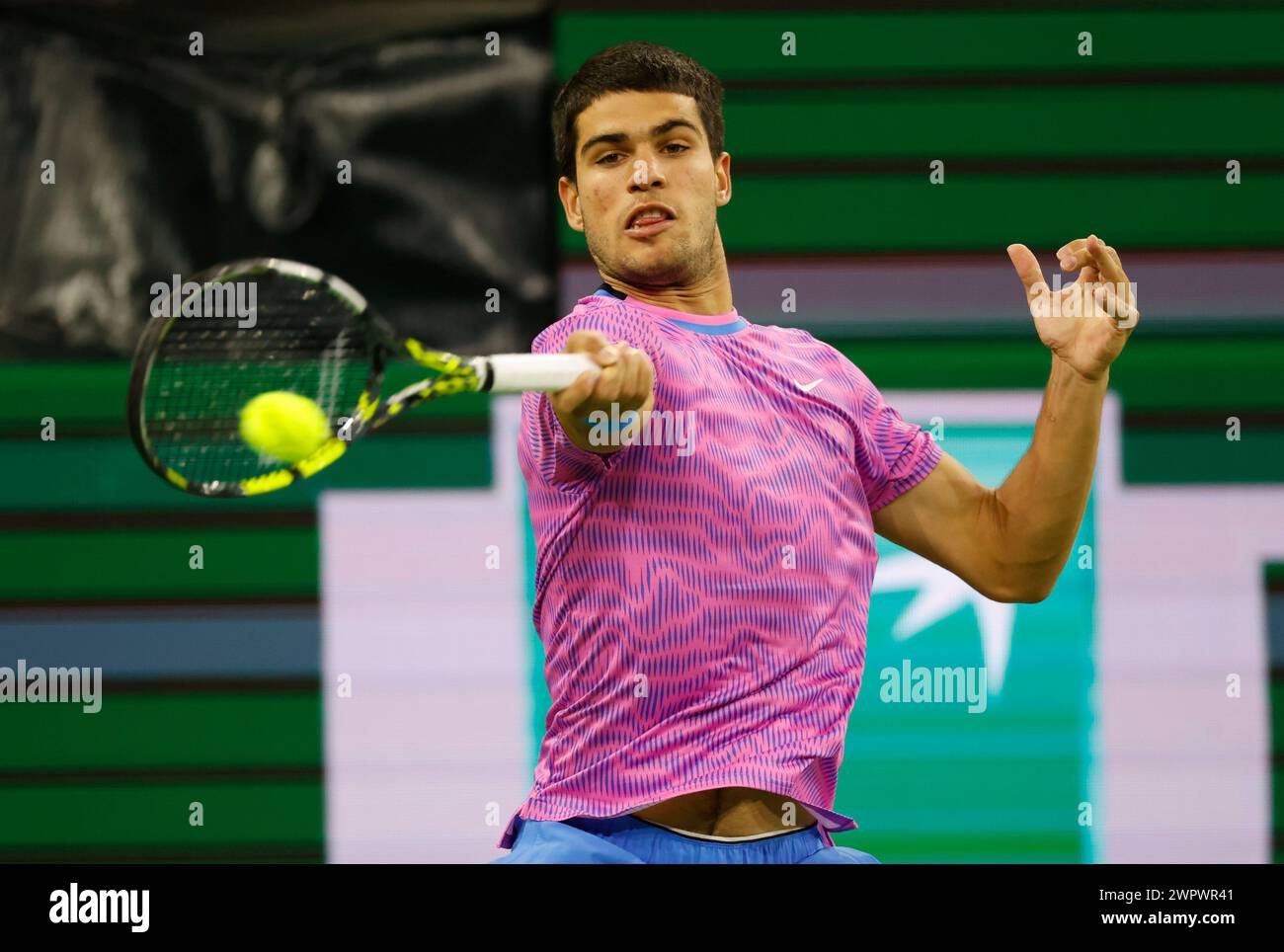 March 08, 2024 Carlos Alcaraz of Spain returns a shot against Matteo