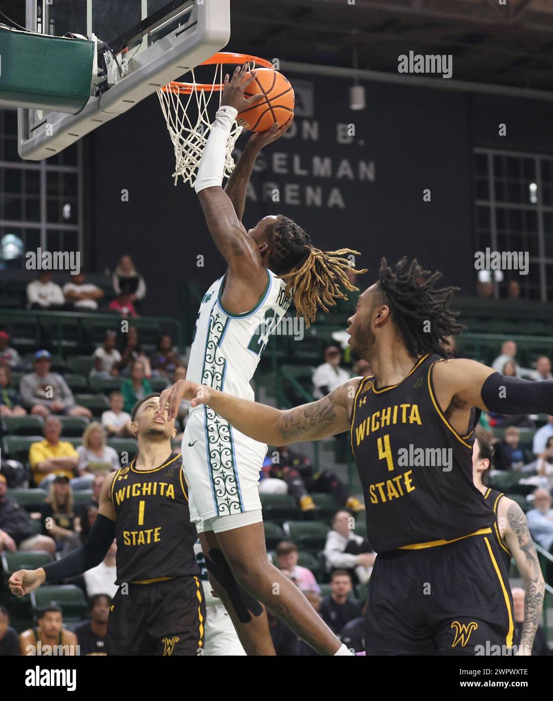 New Orleans, USA. 08th Mar, 2024. Tulane Green Wave guard Jaylen Forbes (25) shoots a layup against a trio of Wichita State Shockers' defenders during an American Athletic Conference men's basketball game at Fogleman Arena in New Orleans, Louisiana on Friday, March 8, 2024. (Photo by Peter G. Forest/Sipa USA) Credit: Sipa USA/Alamy Live News Stock Photo