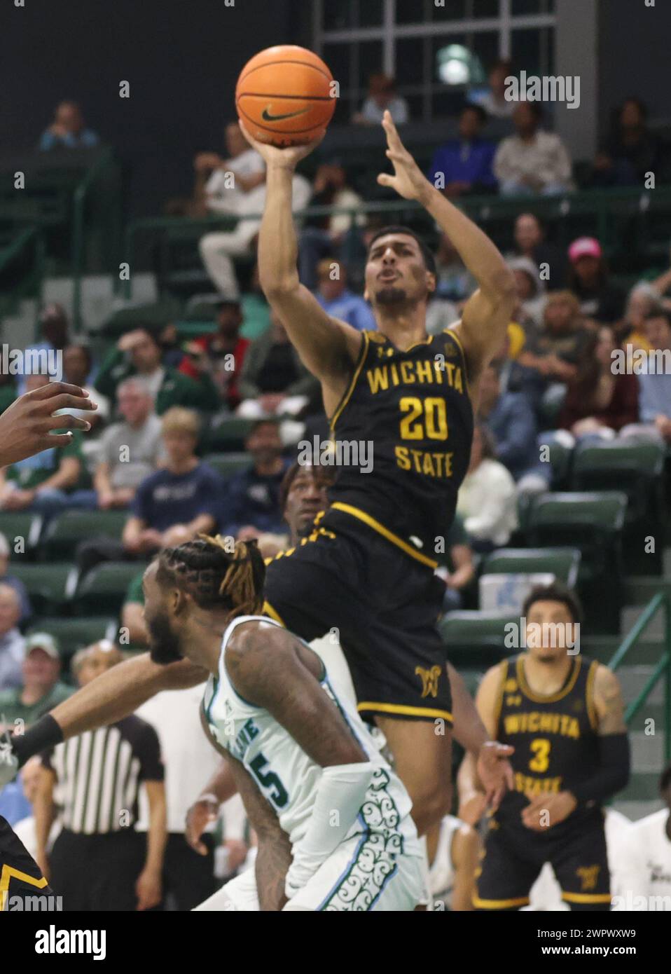 New Orleans, USA. 08th Mar, 2024. Wichita State Shockers guard Harlond Beverly (20) shoots a jumper over Tulane Green Wave guard Jaylen Forbes (25) during an American Athletic Conference men's basketball game at Fogleman Arena in New Orleans, Louisiana on Friday, March 8, 2024. (Photo by Peter G. Forest/Sipa USA) Credit: Sipa USA/Alamy Live News Stock Photo
