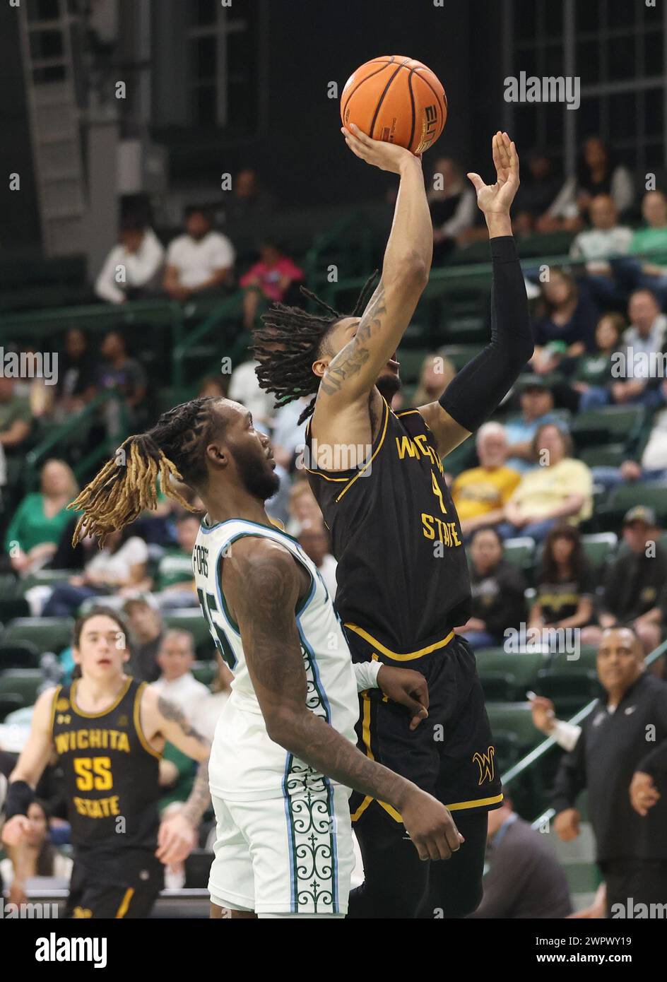 New Orleans, USA. 08th Mar, 2024. Wichita State Shockers guard Colby Rogers (4) shoots a jumper in the paint against Tulane Green Wave guard Jaylen Forbes (25) during an American Athletic Conference men's basketball game at Fogleman Arena in New Orleans, Louisiana on Friday, March 8, 2024. (Photo by Peter G. Forest/Sipa USA) Credit: Sipa USA/Alamy Live News Stock Photo