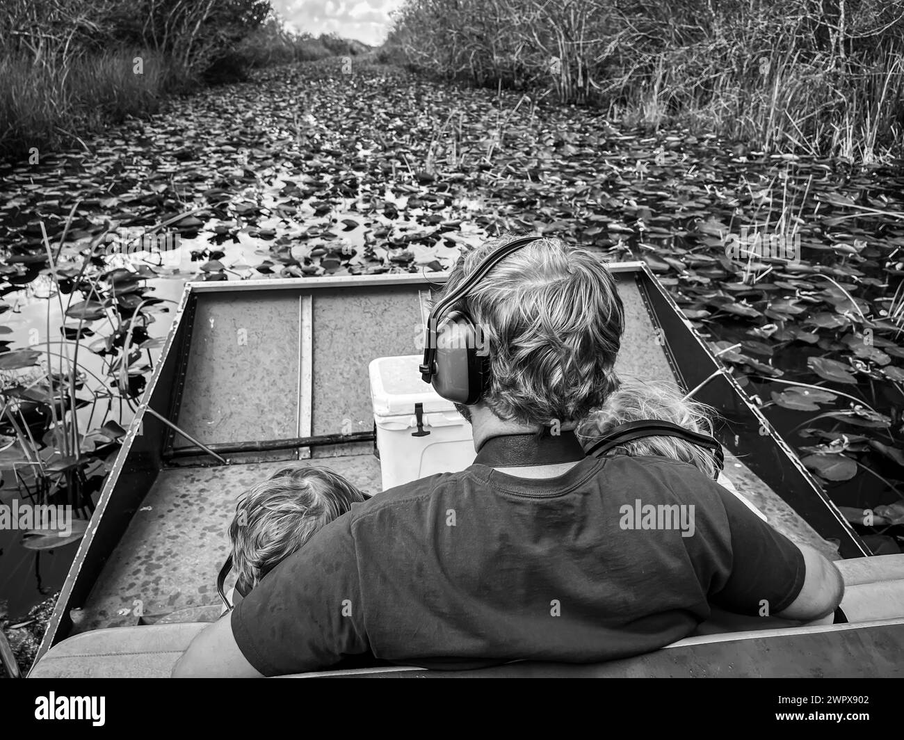 Father and children on an airboat ride in the Florida Everglades Stock