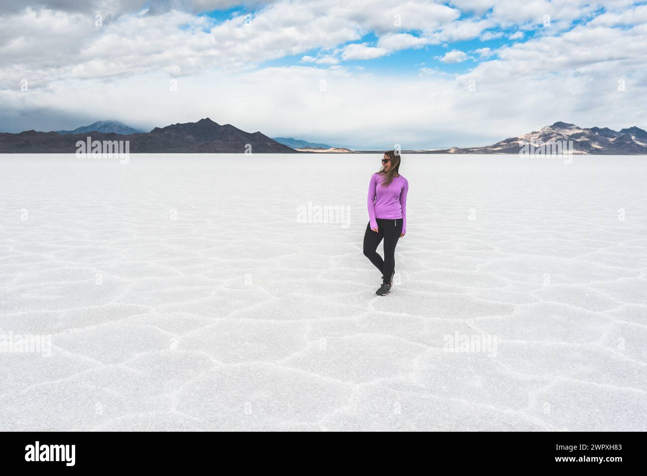 Woman standing on the Bonneville Salt Flats in Utah Stock Photo