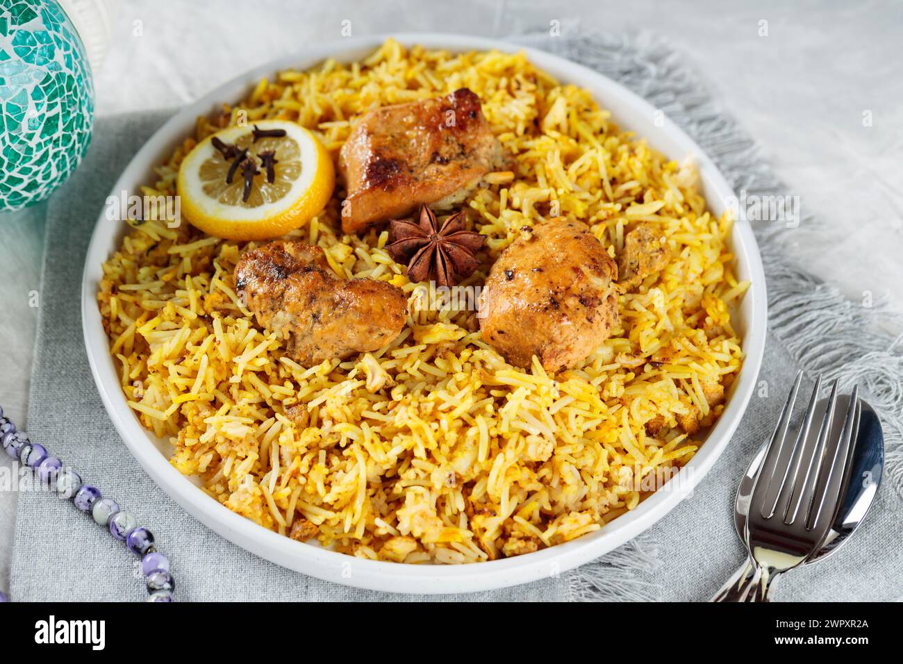 Plate of Traditional Chicken Biryani with Cutlery on Gray Background ...