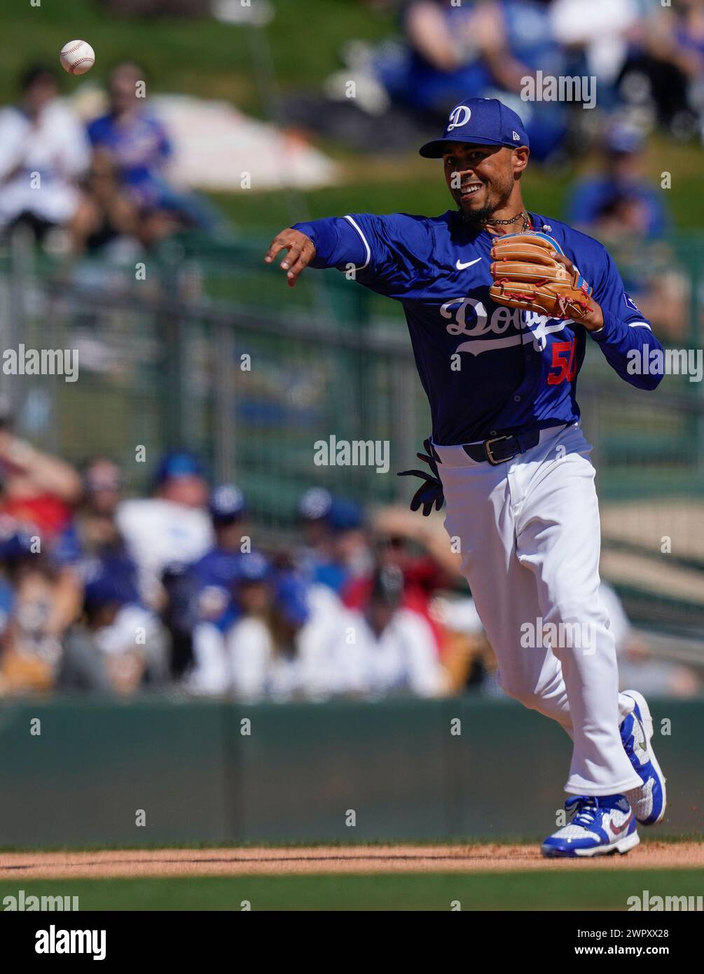 Los Angeles Dodgers shortstop Mookie Betts throws to first to get Texas