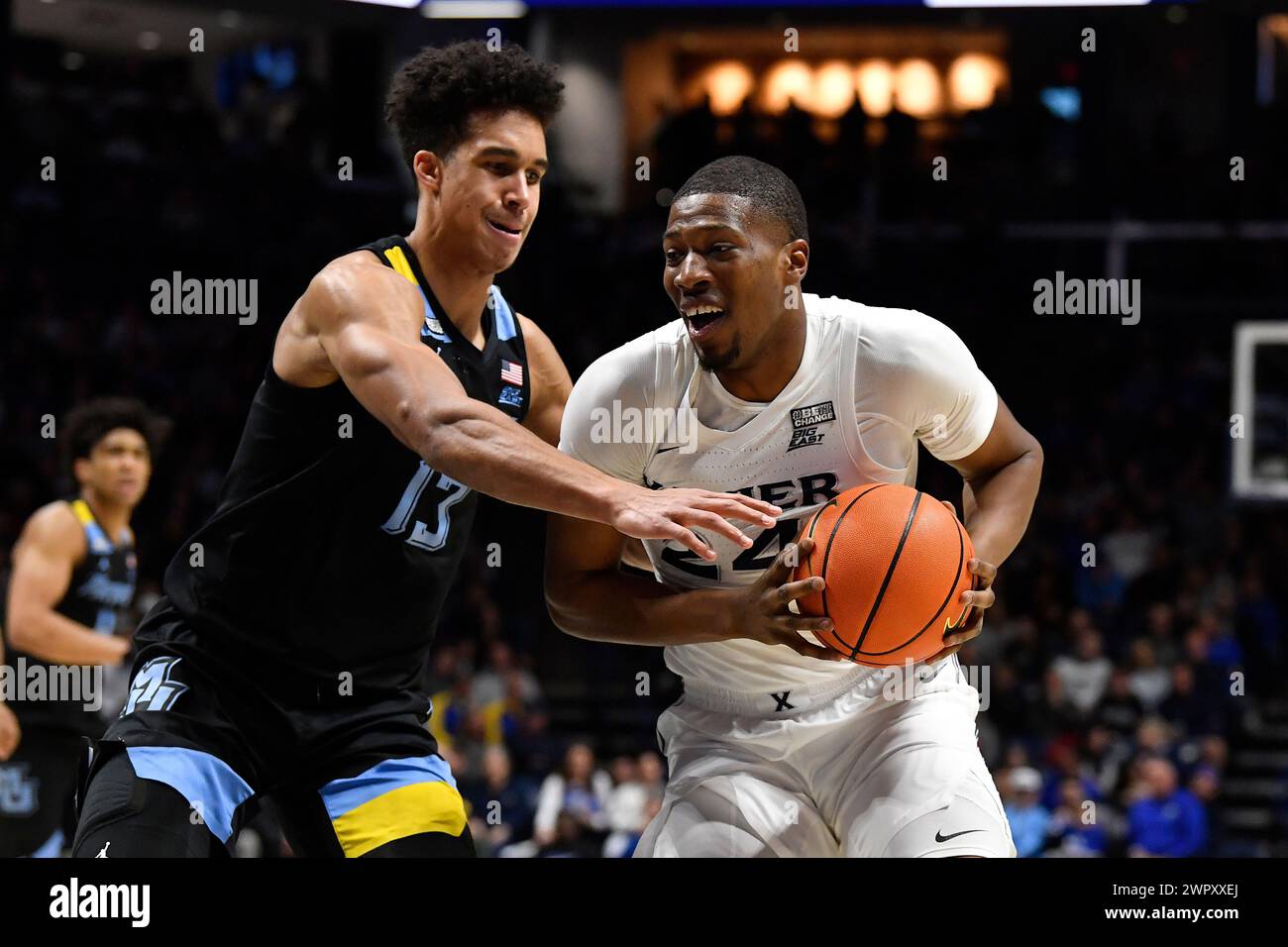 Marquette forward Oso Ighodaro (13) attempts to strip the ball away ...