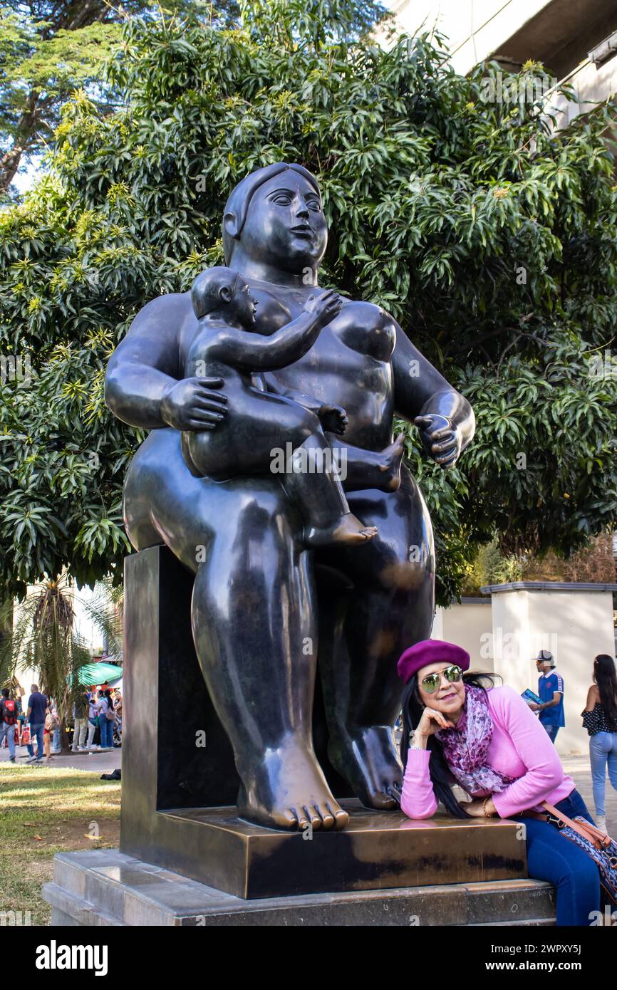 MEDELLIN, COLOMBIA - JANUARY 17, 2024: Tourist visiting the bronze sculptures made by the famous Colombian artist Fernando Botero in Medellin. Materni Stock Photo