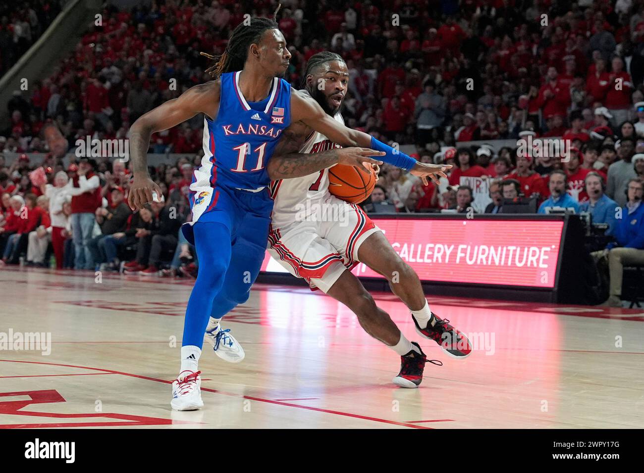 Houston's Jamal Shead (1) drives toward the basket as Kansas's Jamari