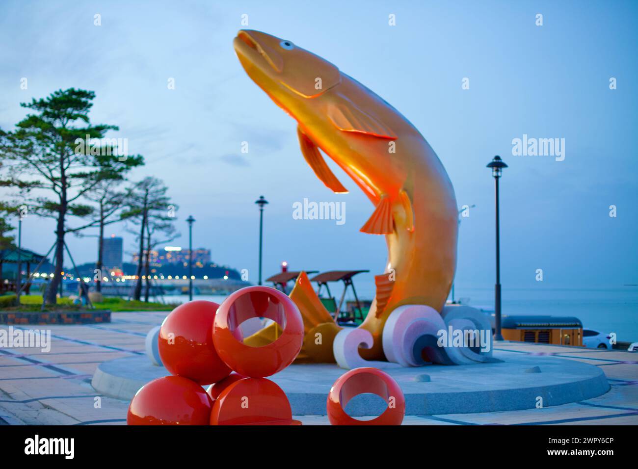 Yangyang County, South Korea - July 30, 2019: A striking 10-meter tall sculpture of a salmon leaping out of the water at Golden Salmon Park, painted r Stock Photo