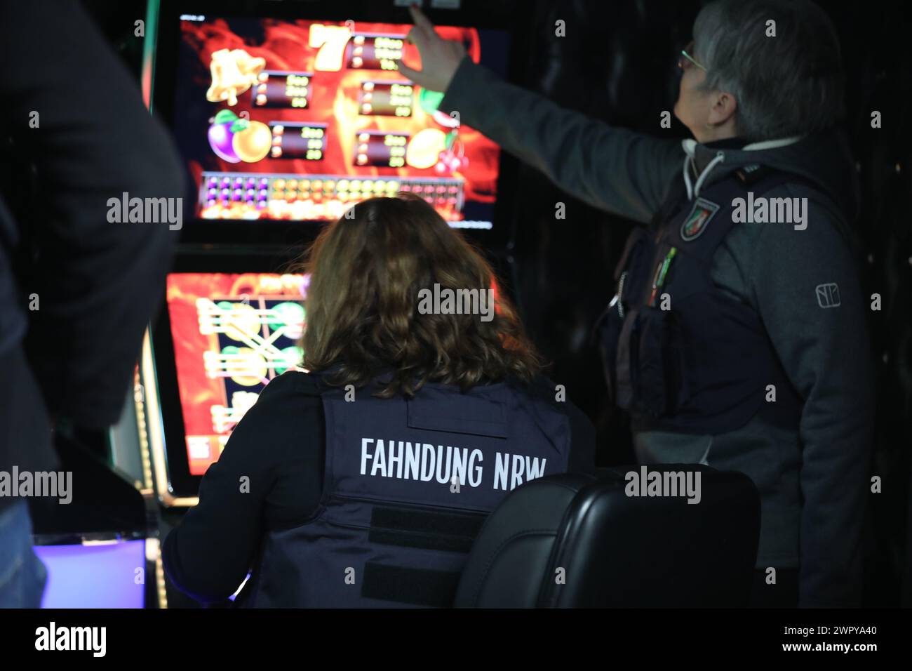 Duisburg, Germany. 09th Mar, 2024. Employees of the NRW tax investigation department check a gambling machine during a search of a gambling hall. Police, customs, the public order office and the tax investigation department jointly searched several properties in Duisburg on suspicion of illegal gambling. Credit: -/dpa/Alamy Live News Stock Photo