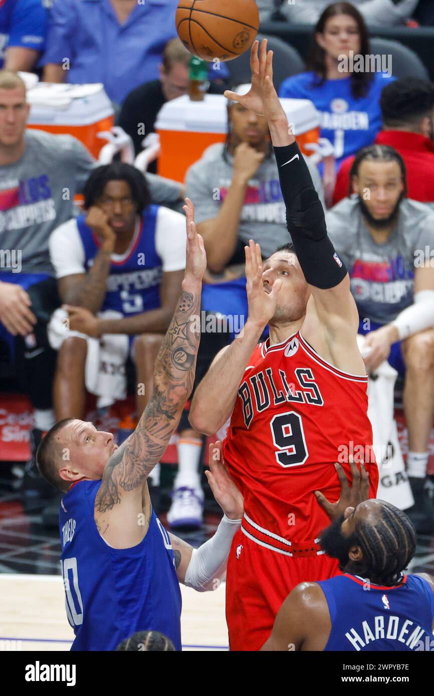 Los Angeles, United States. 09th Mar, 2024. Chicago Bulls' Nikola Vucevic (R) shoots against Los Angeles Clippers' Daniel Theis (L) during an NBA basketball game at Crypto.com Arena. Final score: Clippers 112:102 Bulls Credit: SOPA Images Limited/Alamy Live News Stock Photo