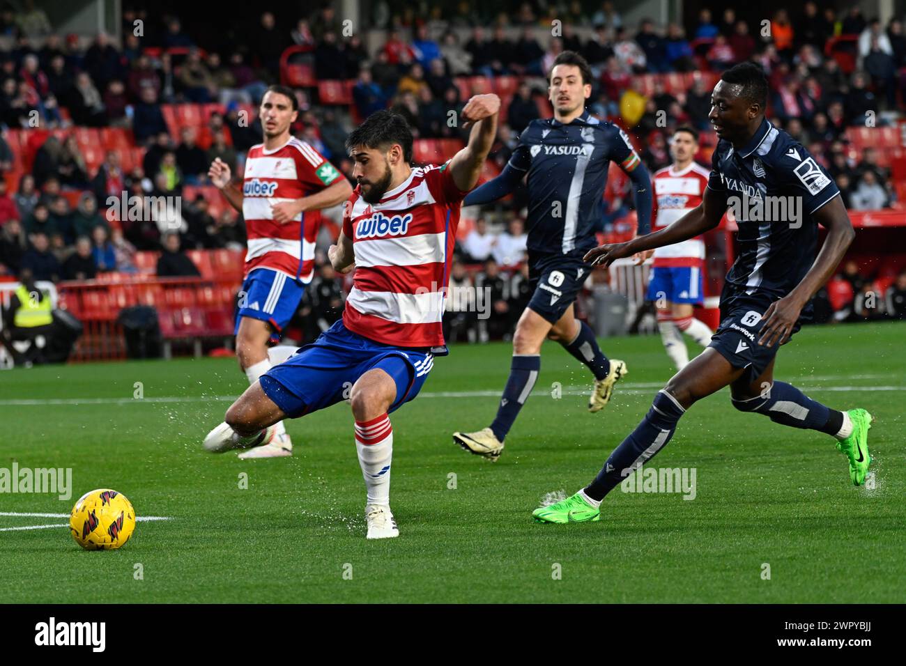 Granada, Granada, Spain. 9th Mar, 2024. Bruno Méndez of Granada CF clears the ball against Umar Sadiq of Real Sociedad during the Liga match between Granada CF - Real Sociedad at Nuevo Los CÃrmenes Stadium on March 09, 2024 in Granada, Spain. (Credit Image: © José M Baldomero/Pacific Press via ZUMA Press Wire) EDITORIAL USAGE ONLY! Not for Commercial USAGE! Stock Photo