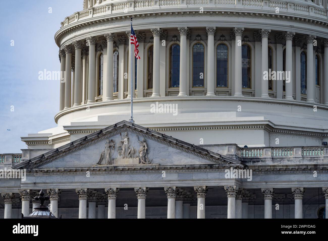 U.S. Capitol Building close-up.  American Flag Flying with Capitol building dome in the background. Stock Photo