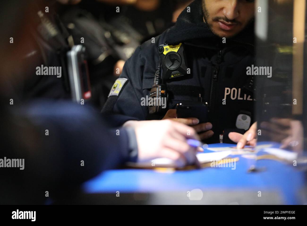 Duisburg, Germany. 09th Mar, 2024. A police officer stands at the counter during a search of a gambling hall. Police, customs, the public order office and the tax investigation department jointly searched premises in Duisburg under suspicion of illegal gambling under the watchful eye of NRW Interior Minister Reul. Credit: -/dpa/Alamy Live News Stock Photo