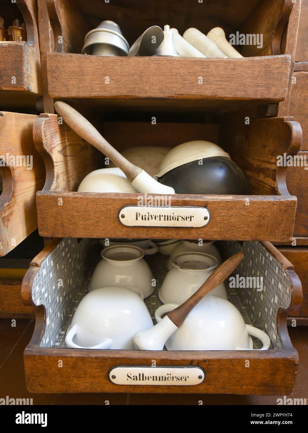 29 February 2024, Saxony-Anhalt, Naumburg: In the museum of the historic Löwen Pharmacy, mortars for the preparation of powders and ointments lie in drawers from a recipe workstation that is over 130 years old. The pharmacy, which has been run by the family of pharmacy manager Dr. Andreas Hünerbein for 120 years, is one of the few establishments of its kind in Germany that has been located in the same place for over 400 years and from which many objects can be displayed in a museum. The museum exhibits include the pharmacy privilege from 1635 issued by the Elector of Saxony, Johann Georg I, to Stock Photo