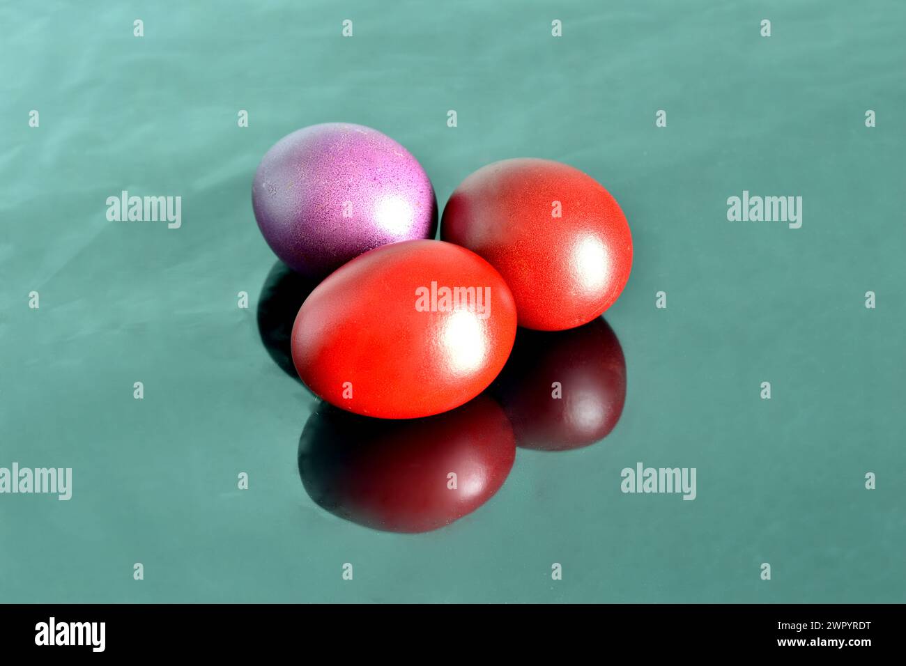 Chicken eggs painted red in honor of Easter. Stock Photo