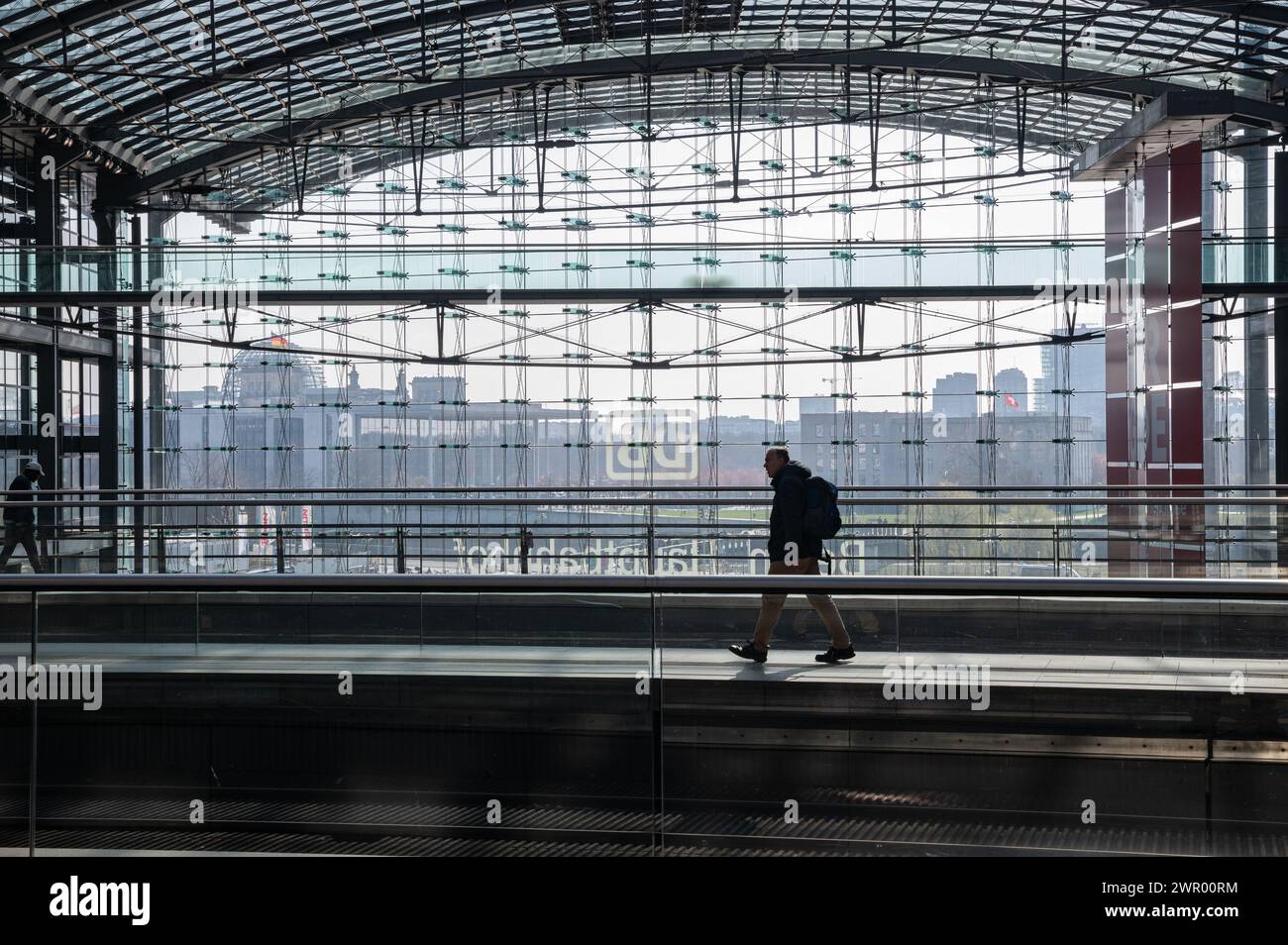07.03.2024, Berlin, Germany, Europe - A rail passenger walks across a platform at an almost deserted Berlin Central Railway Station during a strike. Stock Photo