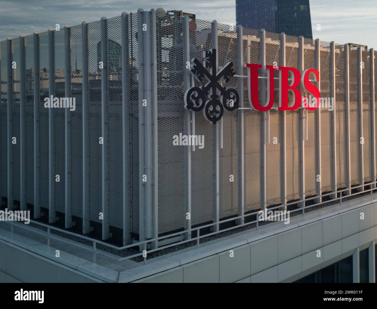 UBS logotype on the top of the UBS office during sunrise. UBS AG is a Swiss global financial services company with its headquarters in Zurich and Base Stock Photo