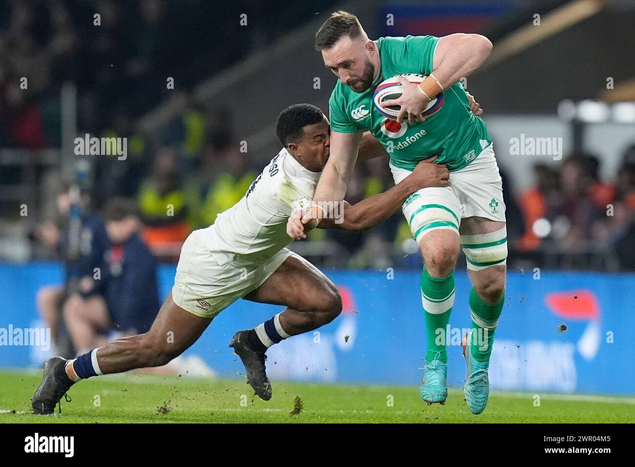 Jack Conan of Ireland hands off Immanuel Feyi-Waboso of England during ...