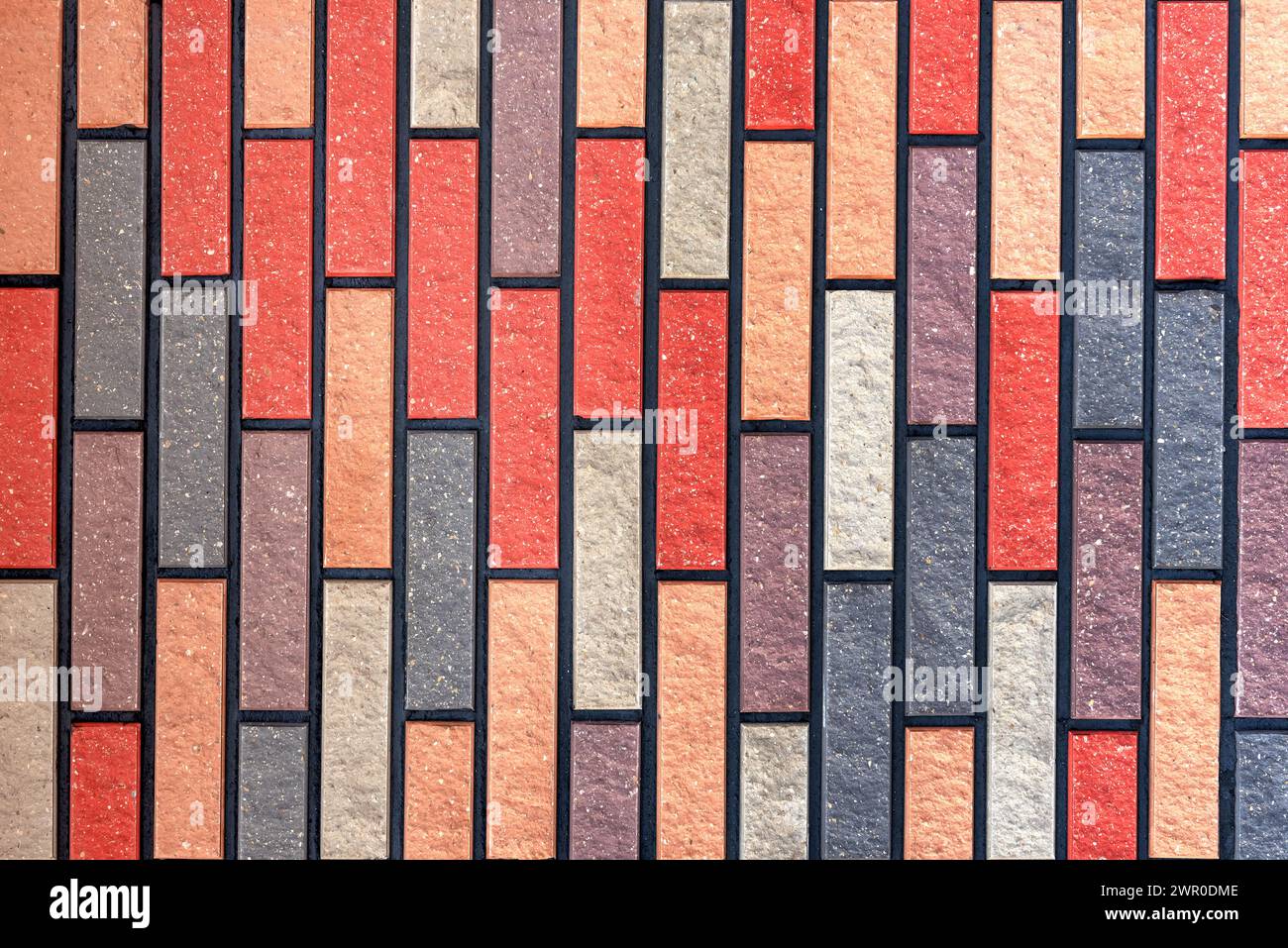 Wall made of multi-colored bricks. Bricks background. Abstract texture Stock Photo