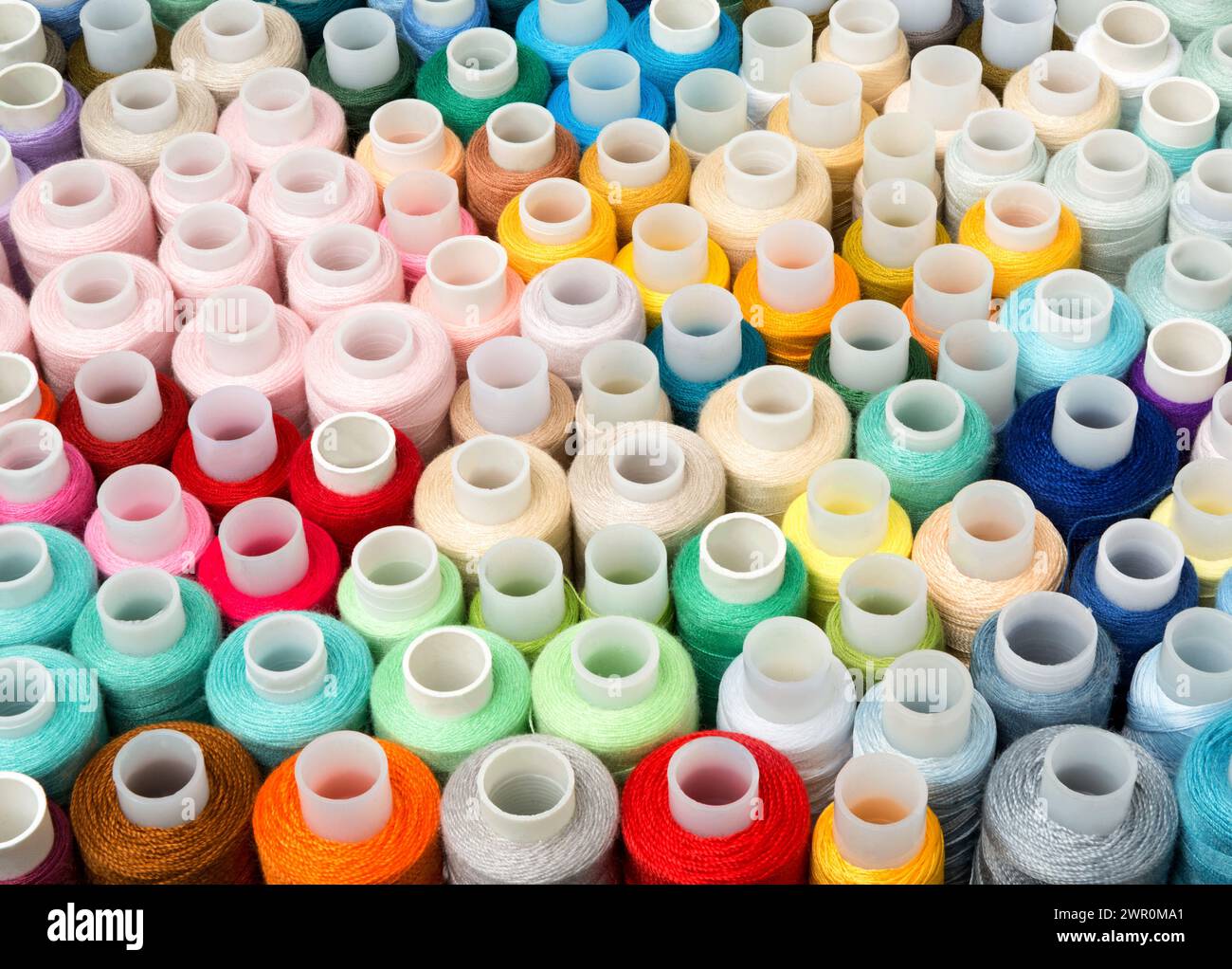 Sewing Thread. Set of different colorful sewing threads as background, top view Stock Photo