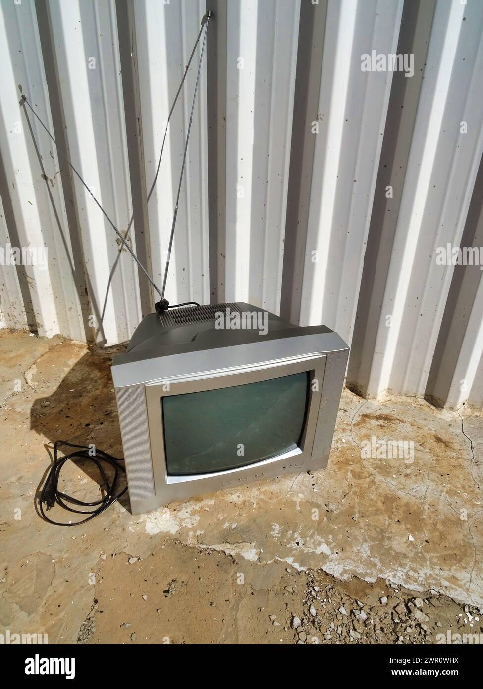 Old TV set abandoned on rusty metal rooftop Stock Photo