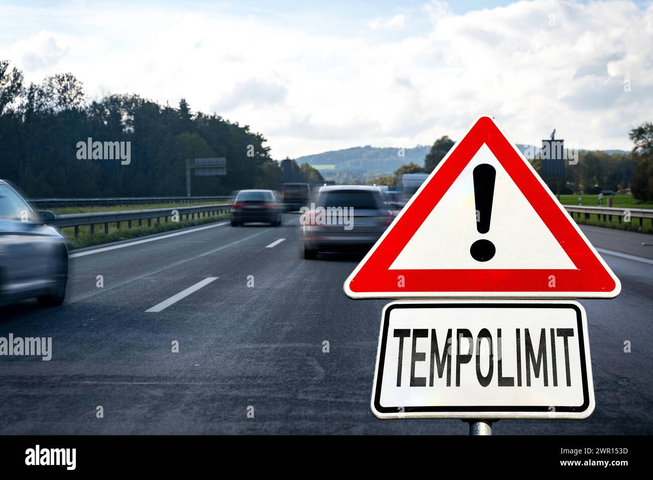 10 March 2024: Speed limit on a traffic sign on a busy freeway in Germany. Symbolic image for speed regulation. PHOTOMONTAGE *** Tempolimit steht auf einem Verkehrsschild auf einer befahrenen Autobahn in Deutschland. Symbolbild für eine Regulierung der Geschwindigkeit. FOTOMONTAGE Stock Photo