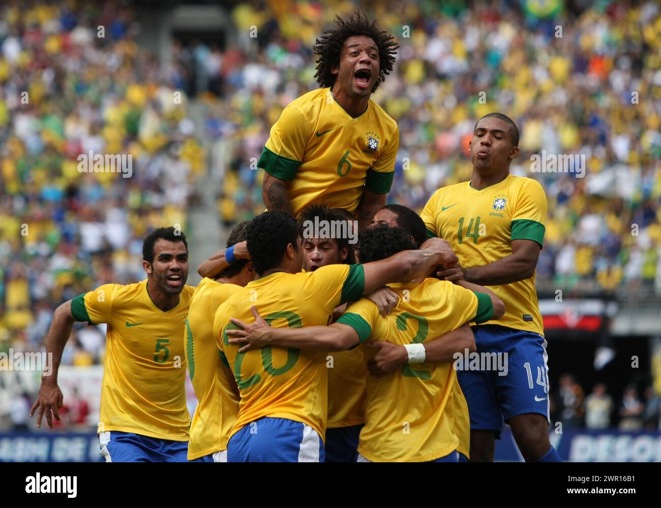 JUNE 09 2012:   Marcelo (6) of Brazil leaps on players celebrating the third Brazil goal by Hulk (20)l during an international friendly match against Argentina at Metlife Stadium in East Rutherford,New Jersey. Argentina won 4-3. Stock Photo