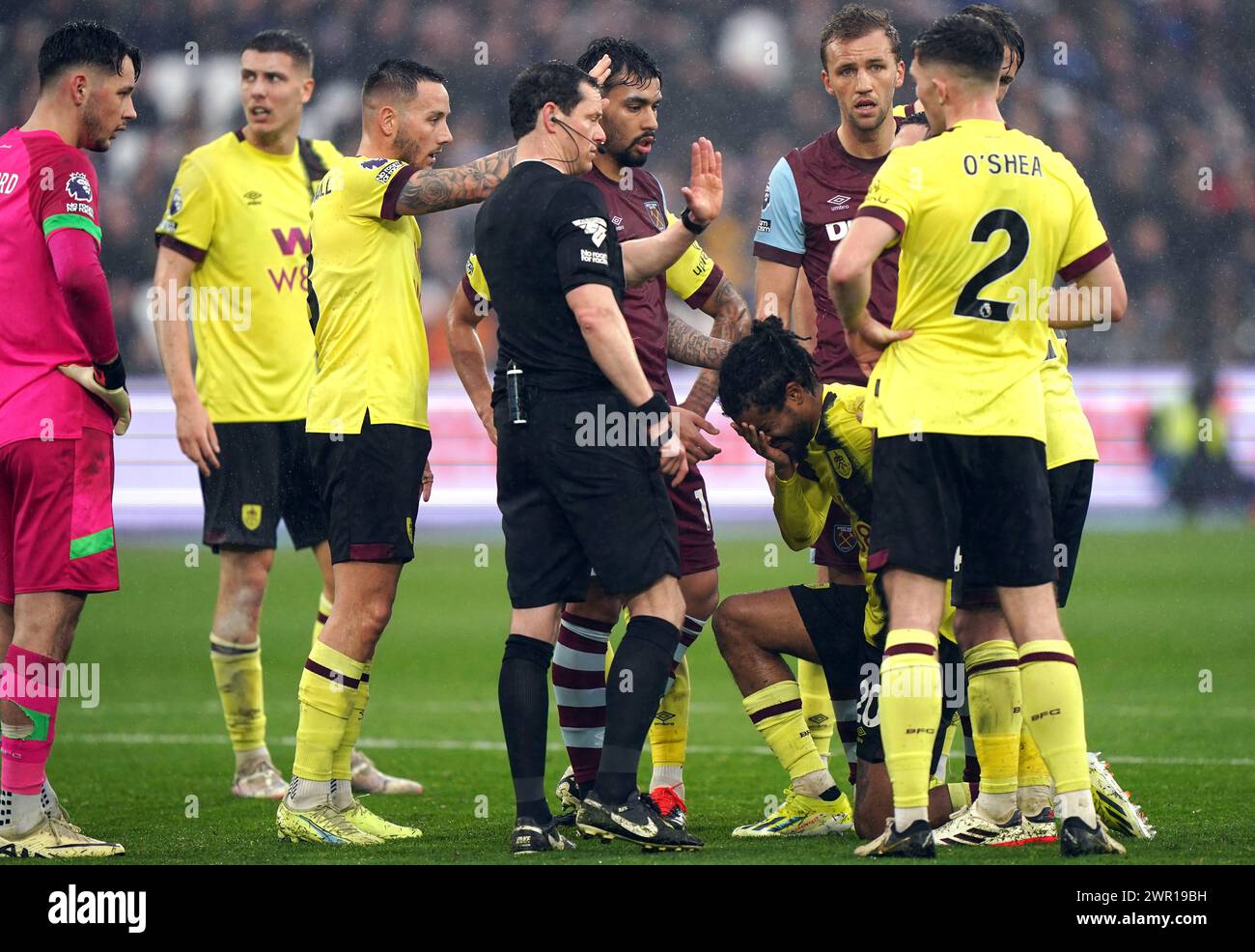 Referee Darren England stops play after Burnley's Lorenz Assignon reacts to being stuck in the face during the Premier League match at the London Stadium, London. Picture date: Sunday March 10, 2024. Stock Photo