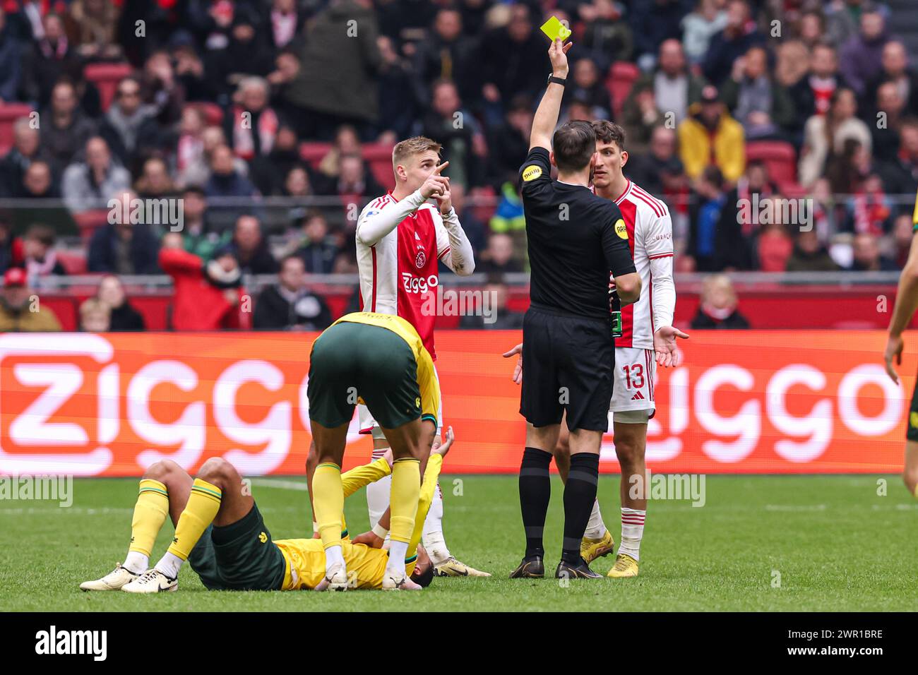 AMSTERDAM, NETHERLANDS - MARCH 10: Ahmetcan Kaplan of AFC Ajax receives a yellow card during the Dutch Eredivisie match between Ajax and Fortuna Sittard at Johan Cruijff ArenA on March 10, 2024 in Amsterdam, Netherlands. (Photo by Peter Lous/Orange Pictures) Stock Photo