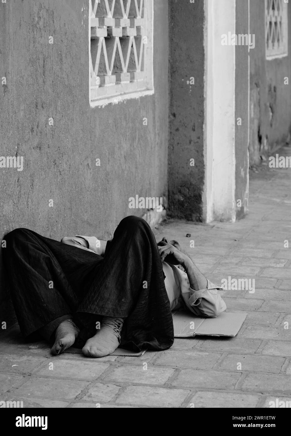 Abyenah , Iran, 07.01.2023: An old man sleeping outside ground, old man tradition cloths. Stock Photo