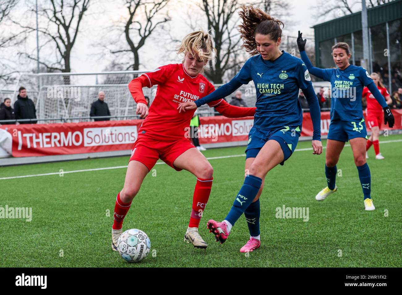 Enschede, Netherlands. 10th Mar, 2024. ENSCHEDE, NETHERLANDS - MARCH 10: Wieke Kapitein of FC Twente, Melanie Bross of PSV battle for the ball during the Dutch Azerion Vrouwen Eredivisie match between FC Twente and PSV at Schreurserve on March 10, 2024 in Enschede, Netherlands. (Photo by Ben Gal/Orange Pictures) Credit: Orange Pics BV/Alamy Live News Stock Photo
