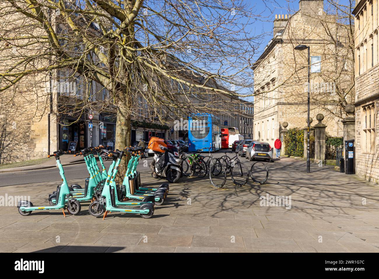 Tier E-scooters, bicycles and buses in Westgate Buildings, Bath City centre, Somerset, England, UK Stock Photo