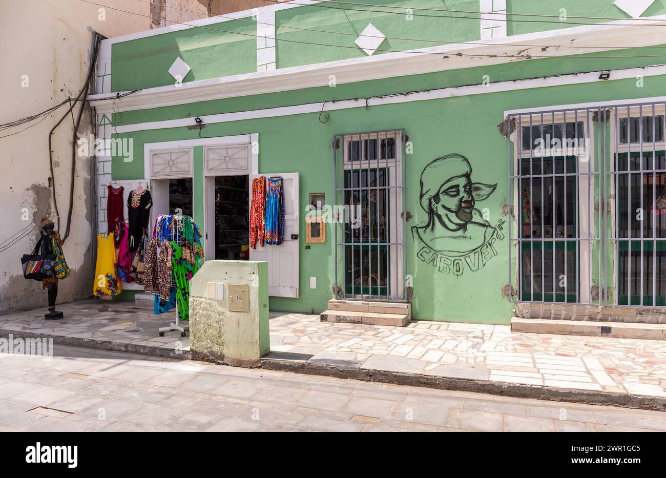 Green painted store in Santa Maria, Sal selling colourful African clothes, Sal, Cape Verde, Africa Stock Photo