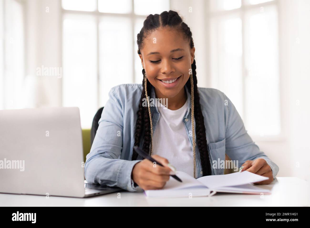 African teen girl studying book hi-res stock photography and images - Alamy