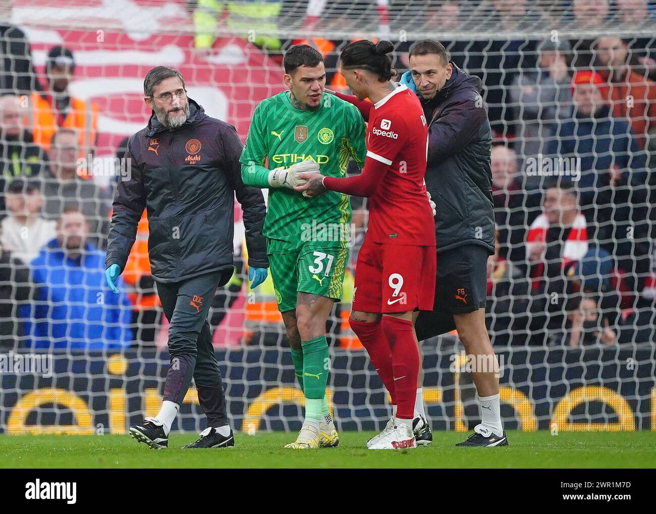 Manchester City goalkeeper Ederson leaves the game with an injury as Liverpool's Darwin Nunez checks on his condition during the Premier League match at Anfield, Liverpool. Picture date: Sunday March 10, 2024. Stock Photo