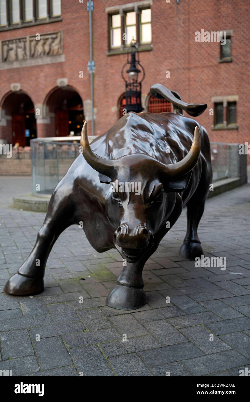 Amsterdam The Netherlands 10th March 2024 On the Beursplein in Amsterdam the Charging Bull statue between the Beurs van Berlage and the AEX stock exchange Beursplein 5. sculpture, statue, Stock Photo