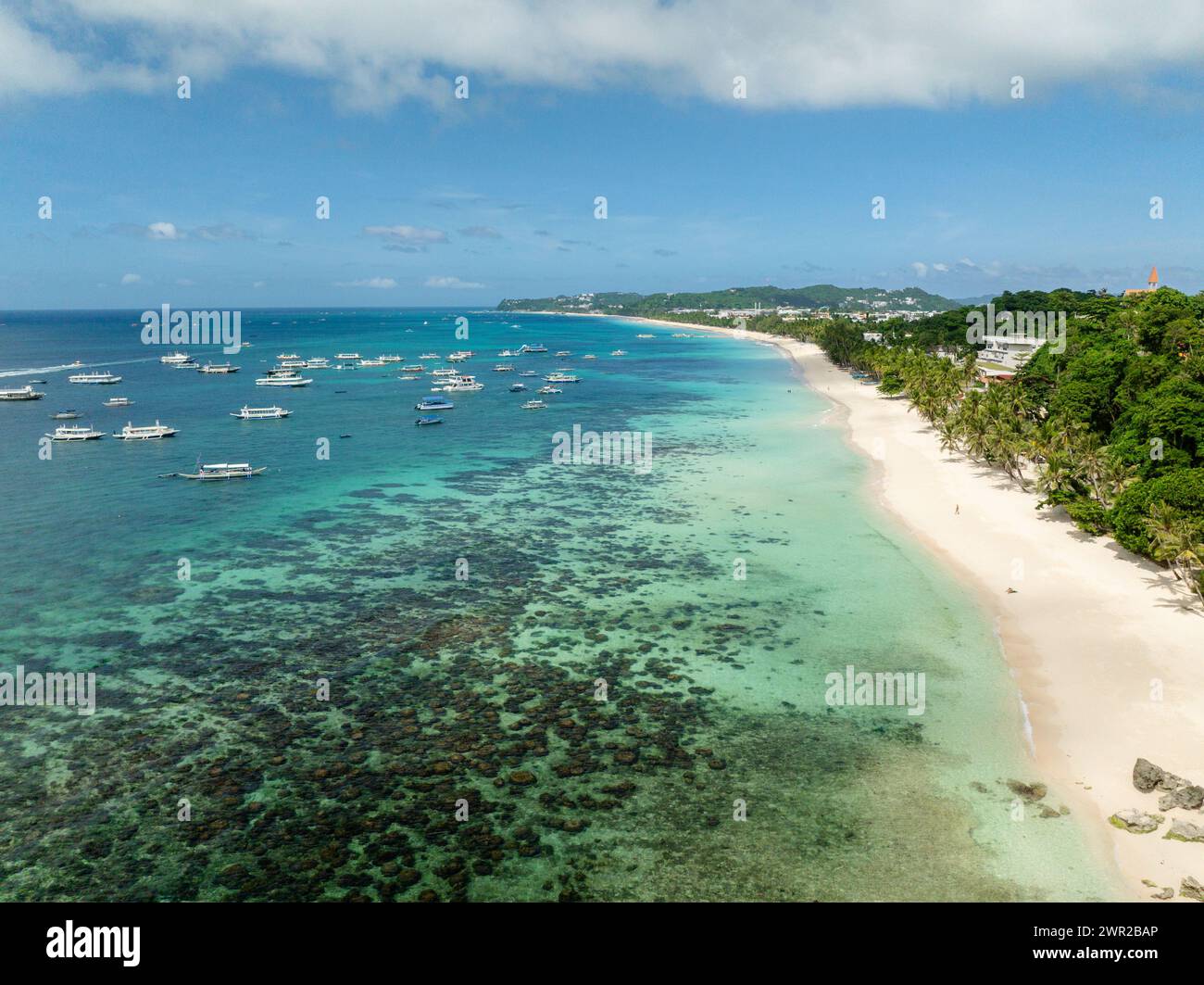 Tropical white sandy beach and transparent turquoise sea water with boats. Boracay, Philippines. Stock Photo