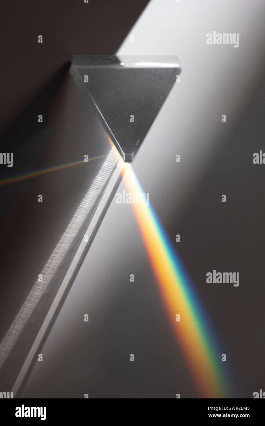 Prism dispersing light to  spectrum of rainbow colors Stock Photo