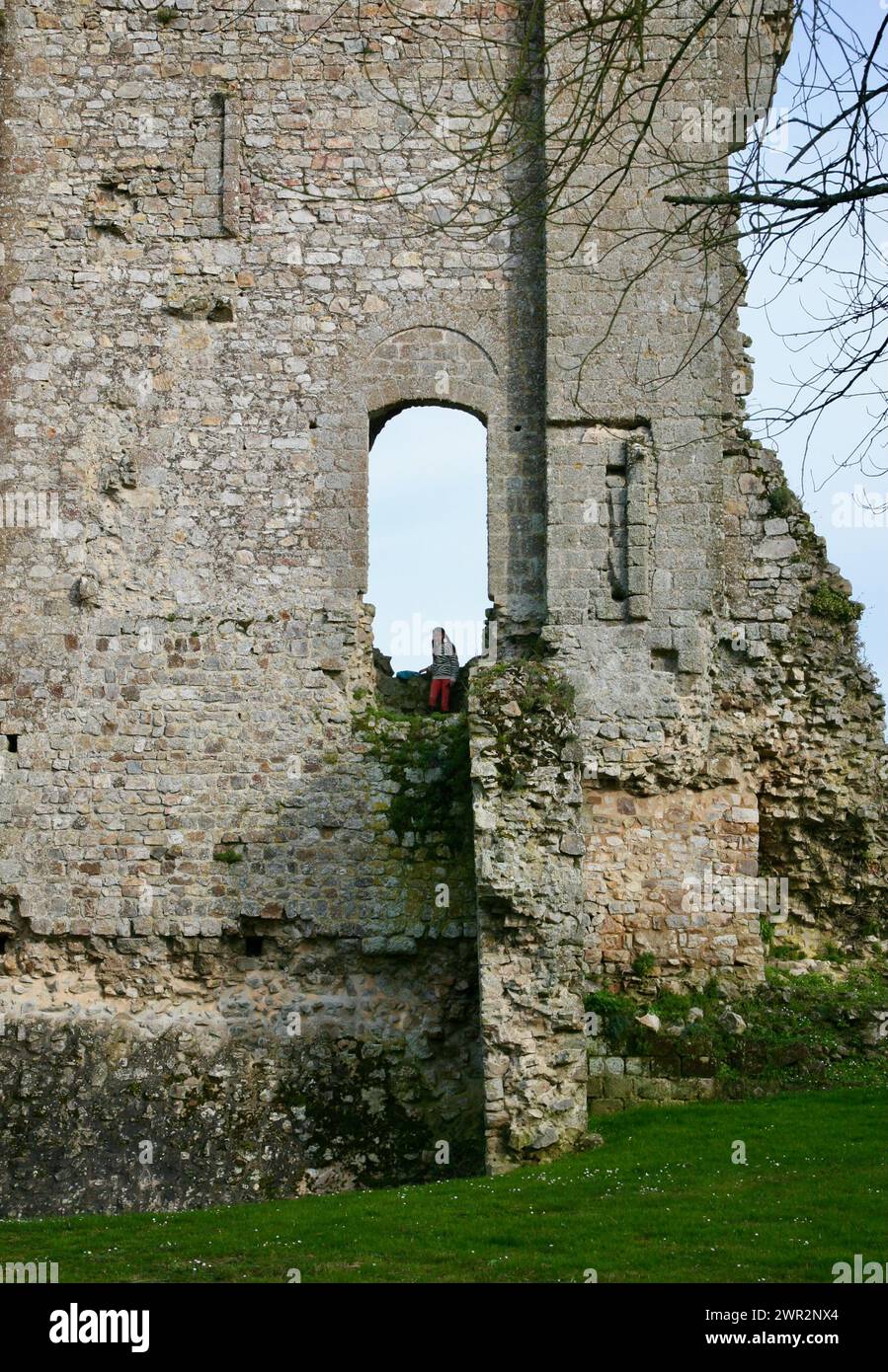 A view of a young girl climbing the walls of the chateau, at Domfront-en-Poiraie in Normandy, France, Europe Stock Photo