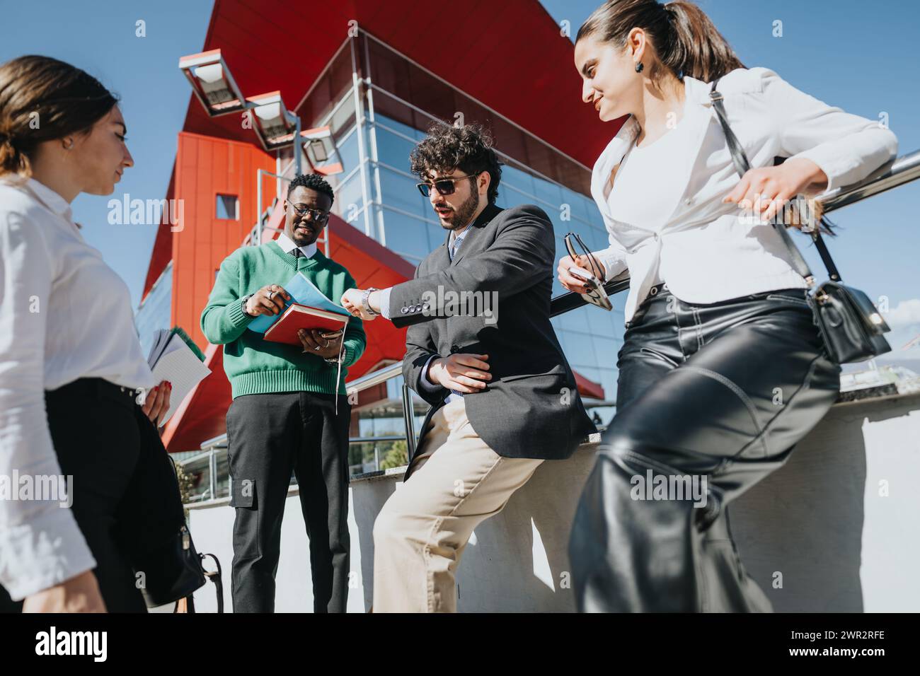 Multicultural business team discussing strategy outdoors Stock Photo ...