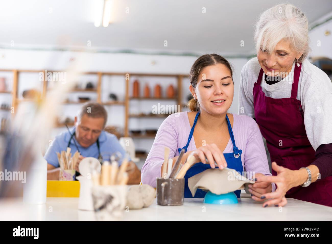 girl in workshop of experienced potter woman Stock Photo