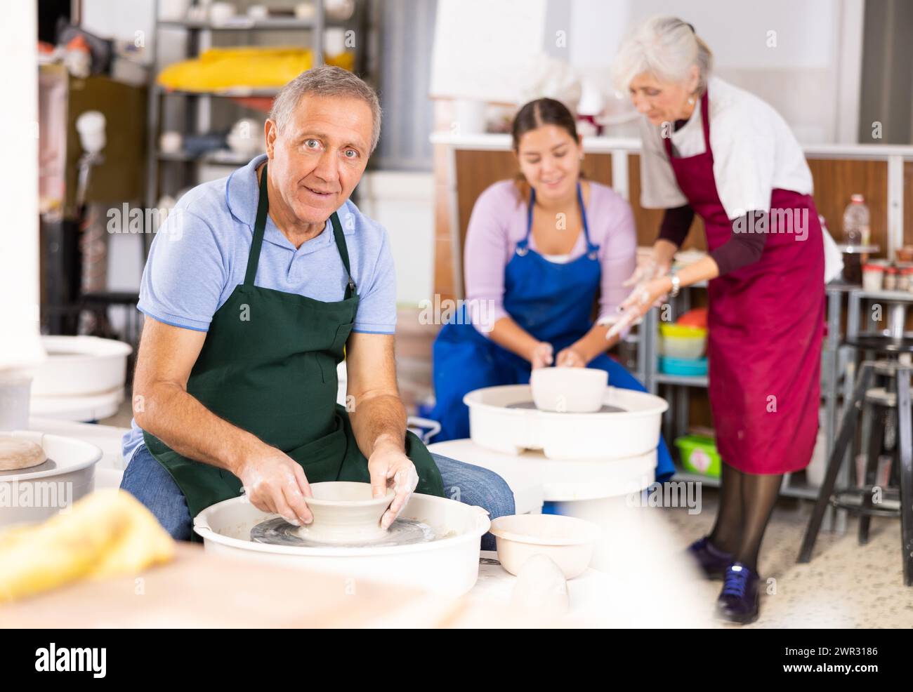 Mature male artist making pottery in studio Stock Photo - Alamy