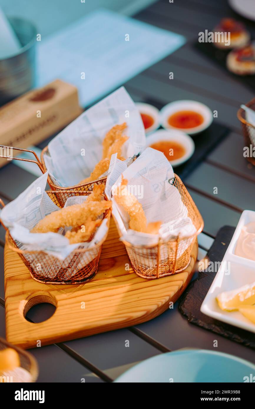 Delicious fried shrimps elegantly served with sauces on the restaurant table, Portugal Stock Photo