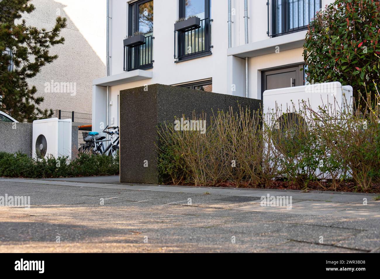 Two heat pumps in the front garden of terraced houses in Duesseldorf, North Rhine-Westphalia, Germany Stock Photo