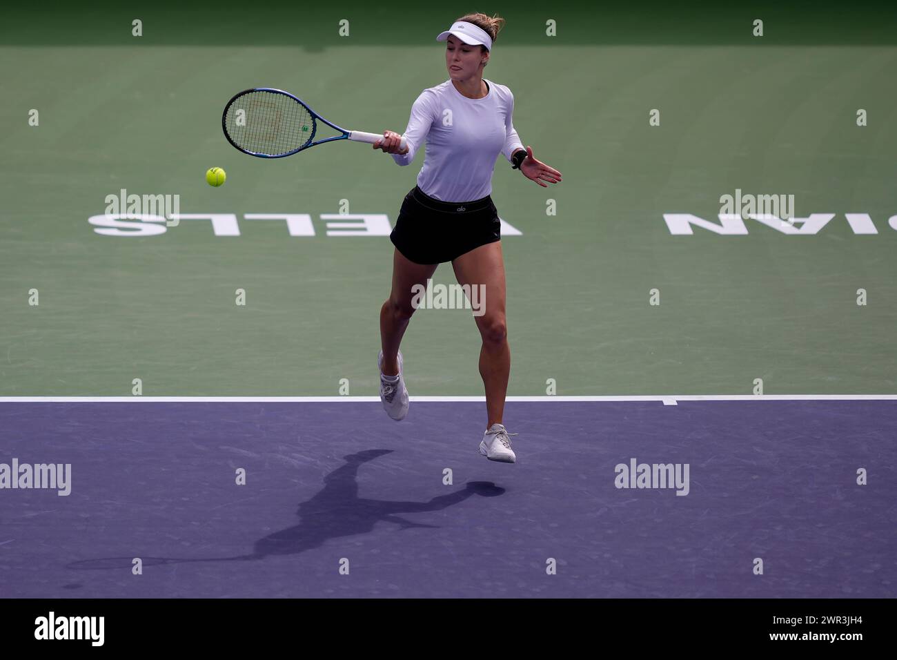 Anna Kalinskaya, of Russia, returns a shot against Jasmine Paolini, of